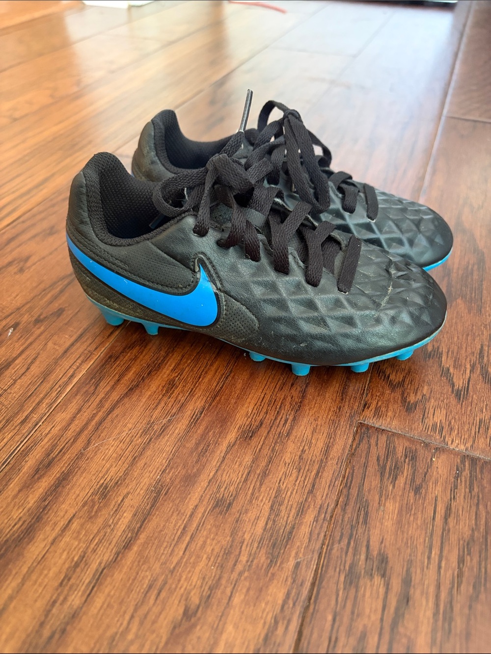Nike Kids Black Soccer Cleats with Blue Swoosh
